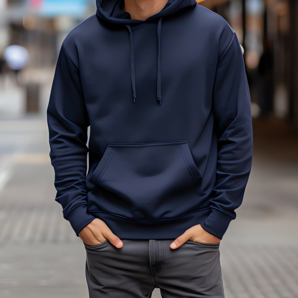 Person standing in an urban setting wearing a hoodie